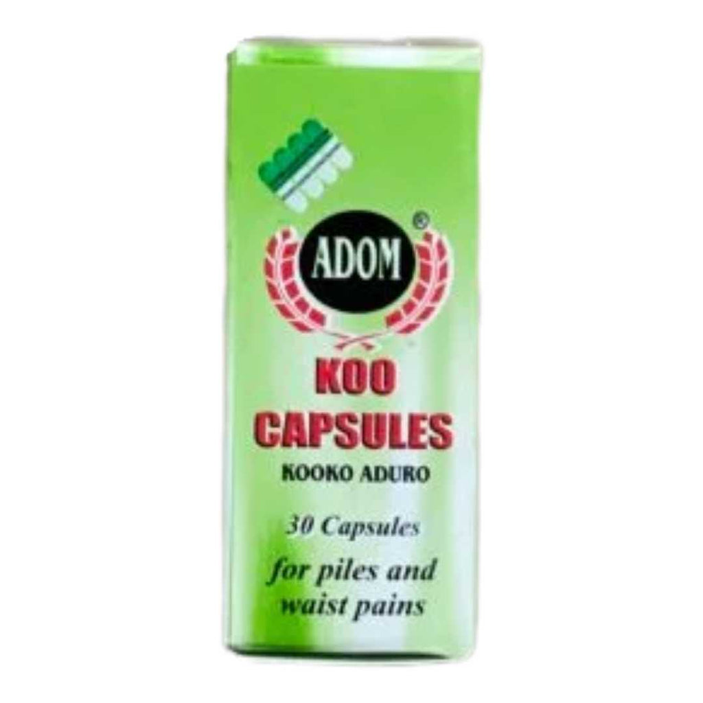 Green bottle and matching box of Adom Koo herbal capsules — a Ghanaian herbal supplement for relief from constipation, piles, waist pains, and excess phlegm.