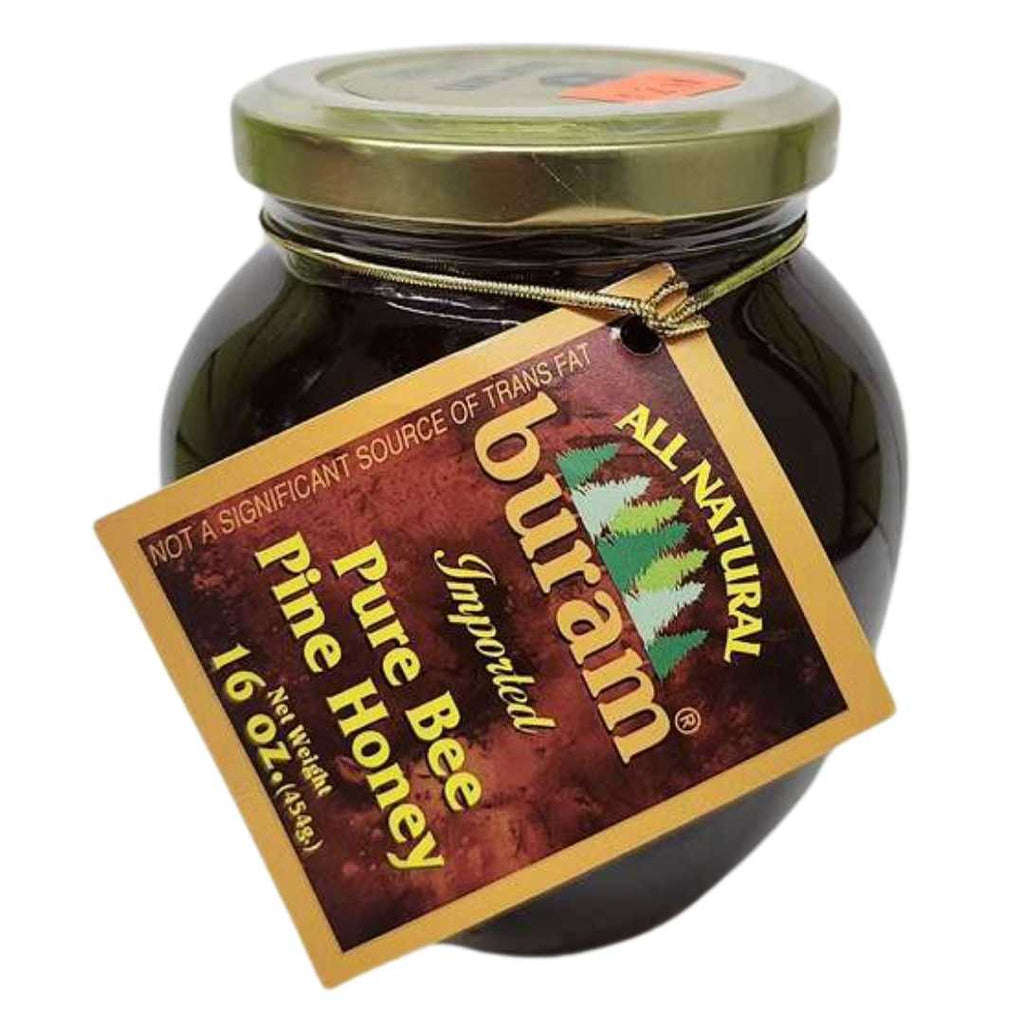 Buram All-Natural Imported Pure Bee Pine Honey 16 oz jar – dark golden honey in a round glass jar with a gold lid and a brown label tag featuring pine trees and product details.
