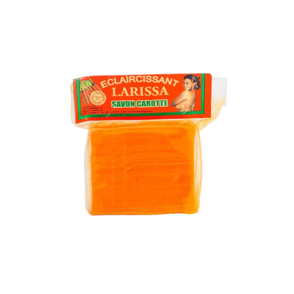 Bar of carrot soap labeled "Savon Carotter," an artisanal orange-toned soap made with natural carrot extract.