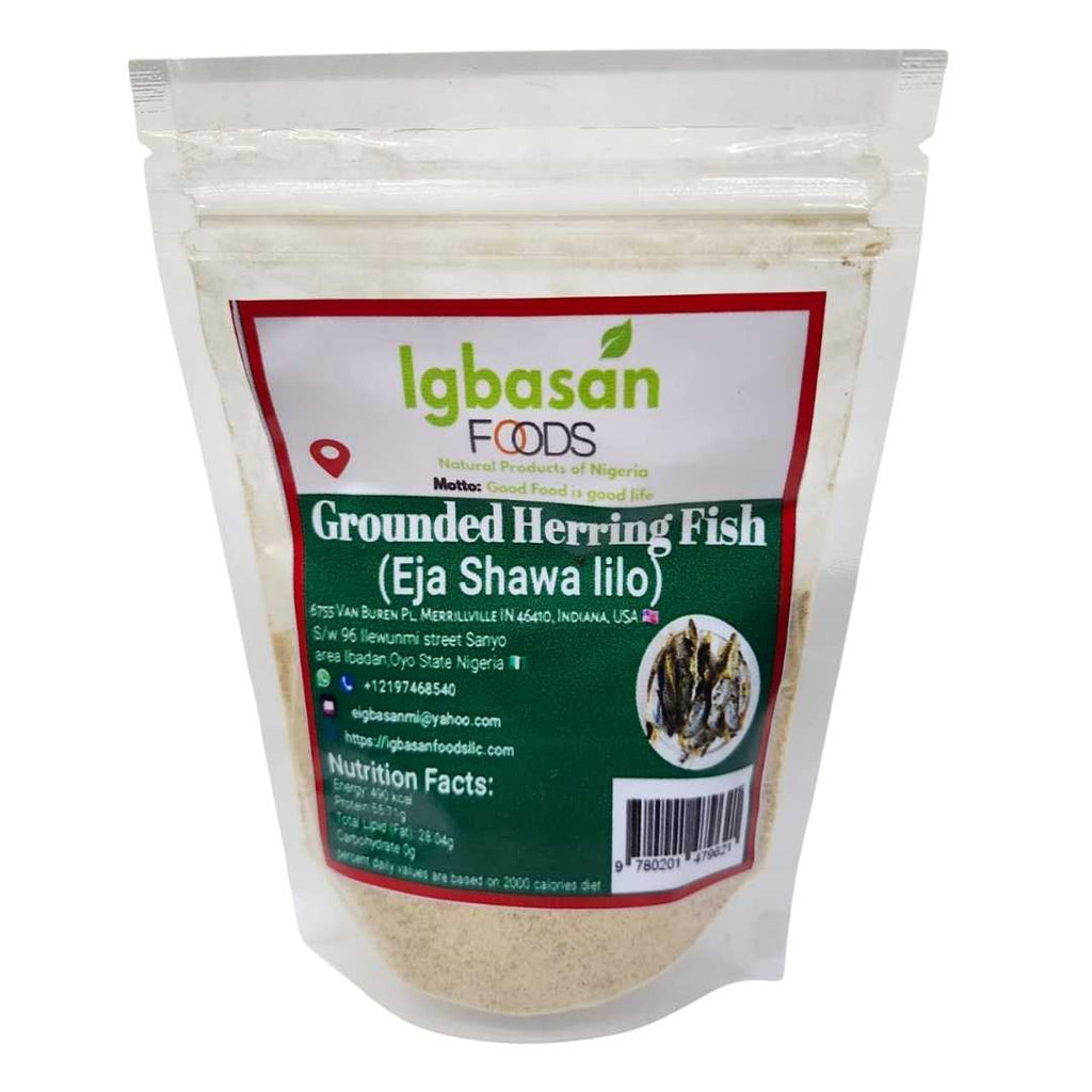 A resealable pouch of Igbasan Foods Grounded Herring Fish (Eja Shawa Iilo) with a green and white label. The label features the Igbasan Foods logo, contact details, nutrition facts, and an image of dried herring fish.