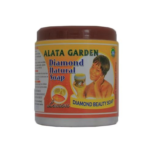Diamond Garden Natural Alata Soap 600g in a clear package, showing brown traditional African black soap with a green and yellow product label featuring natural elements.