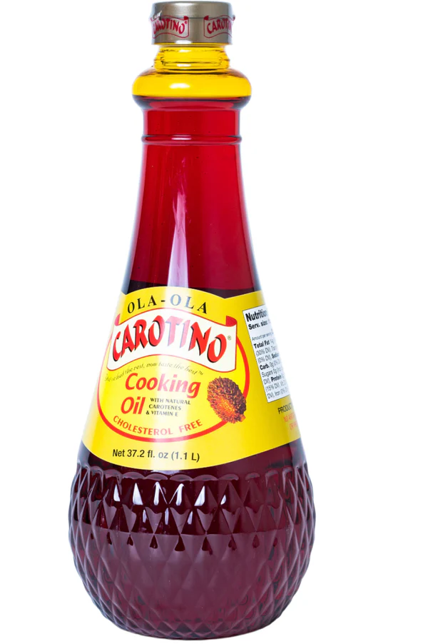 Bottle of Carotino Palm Cooking Oil labeled "Cholesterol Free" with red and yellow packaging.